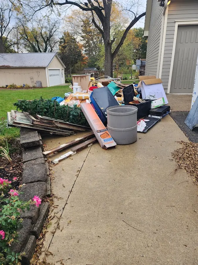 Dumpster being loaded with debris for Estate Cleanout Dumpster Rental in Pleasant Run Farm